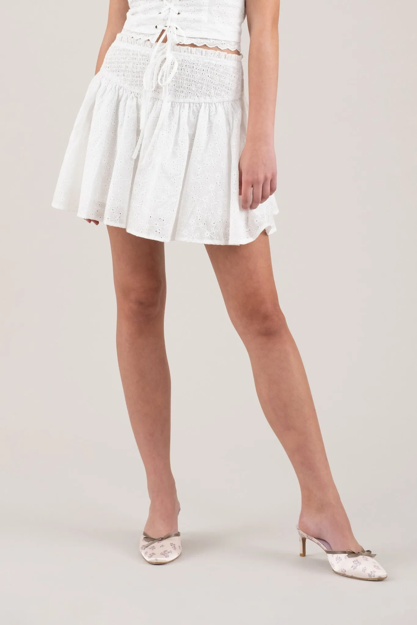 EMBROIDERED EYELET SMOCKED MINI SKIRT