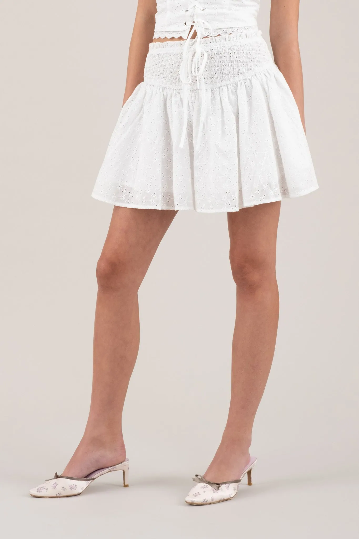 EMBROIDERED EYELET SMOCKED MINI SKIRT